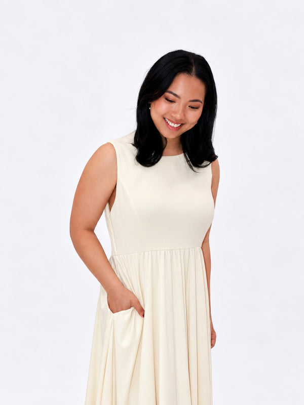 Mum in the Butter dress with a hand in the pocket, the feeding opening hidden in the side seam