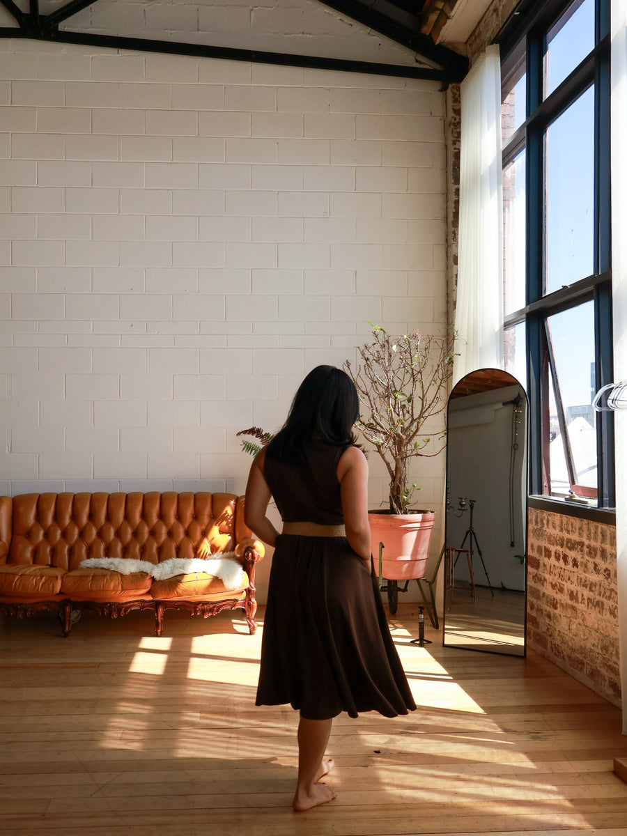 Mum in the Dark Chocolate dress standing alone in a sunlit room